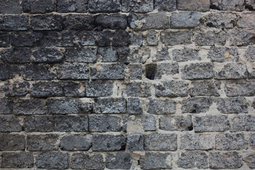 Fototapeta na wymiar Brick masonry with rich and various texture