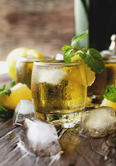 Glass of whiskey with mint and lemon