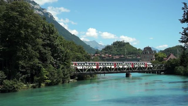 A SWISS SBB DOUBLE DECKER TRAIN AUGUST 3 2015 Crossing a bridge over the River Aare in Interlaken Switzerland.