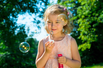 portrait of a beautiful girl with soap bubbles