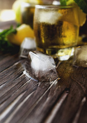 Glass of whiskey with mint and lemon