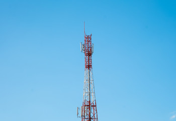 Telecommunication tower with antennas with blue sky background