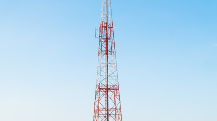 Telecommunication tower with antennas with blue sky background