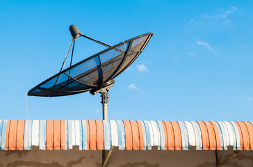 Big Black Satellite Dish on the roof with blue sky