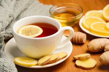 Black tea with lemon, ginger and honey on the wooden table. Horizontal permission. Selective focus.
