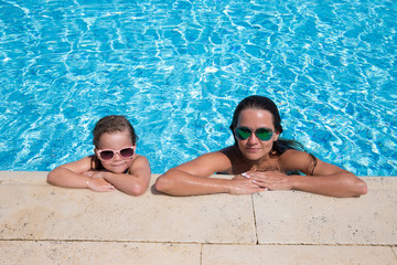 happy little girl and mother in pool