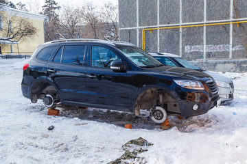 Obraz na płótnie Canvas stolen car without wheels winter morning on the Russian car park
