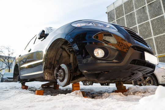 Stolen Car Without Wheels Winter Morning On The Russian Car Park Bottom View