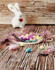Easter colored eggs, feathers, blue wooden