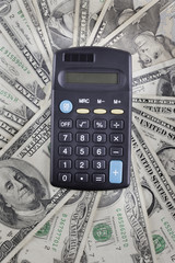 calculator on the background of american dollars banknotes