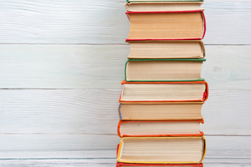 Stack of books on wooden table. Back to school. Copy space