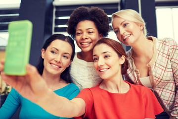 happy young women taking selfie with smartphone