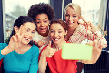 happy young women taking selfie with smartphone
