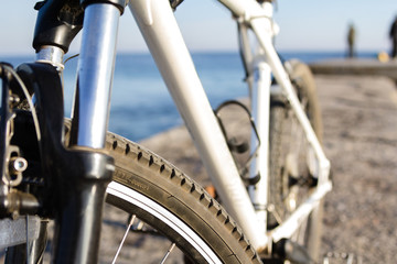 Close up on a bike parked in front of the seaside