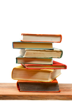 Stack of books at wooden shelf isolated on white background. Back to school. Copy space for text