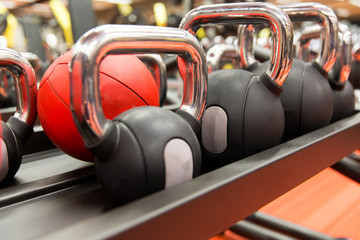 close up of kettlebells and medicine ball in gym