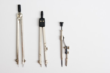 Workplace of architect - divider compass on table. Engineering tools view from the top. Construction background.