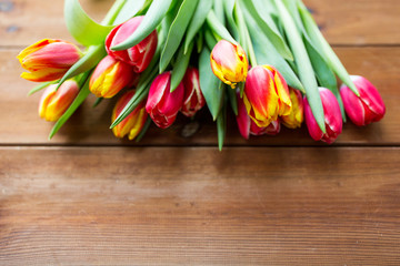 close up of tulip flowers on wooden table