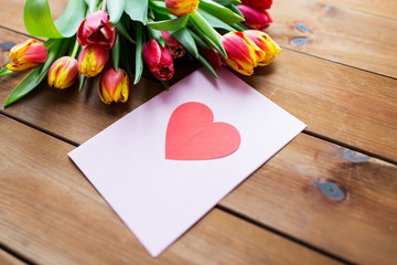 close up of flowers and greeting card with heart