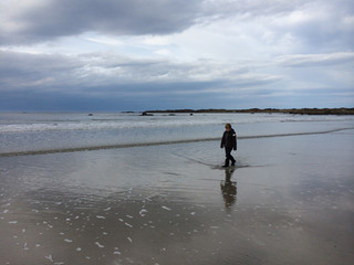 Walking on a grey beach