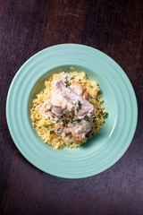 Stewed rabbit meat in creamy sauce with herbs and couscous.