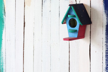colorful bird house on grunge background.