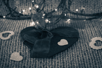 Small white decorative heart on a big felt heart with bow