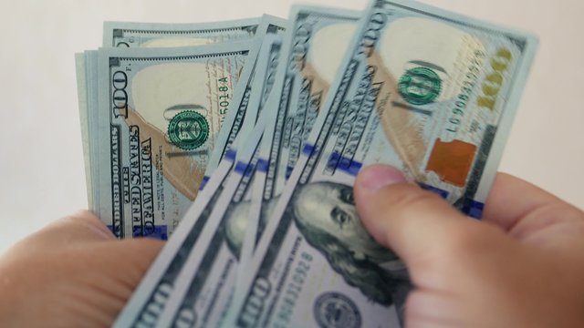 Person counting new money in hands. Lot of one hundred new US dollars banknotes. Cash, money, ready money, Finance & Business. Financial income, wages, sell, loan