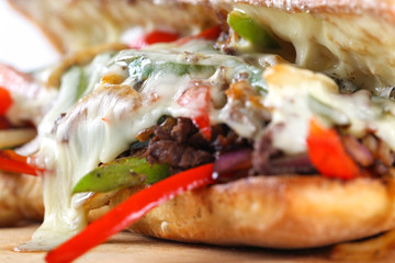 Tasty beef steak sandwich with onions, mushroom and melted provolone cheese in a ciabatta