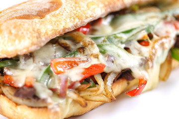 Tasty beef steak sandwich with onions, mushroom and melted provolone cheese in a ciabatta