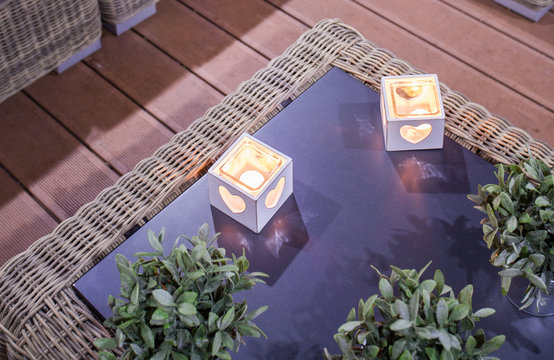 Stylish candleholders on glass table