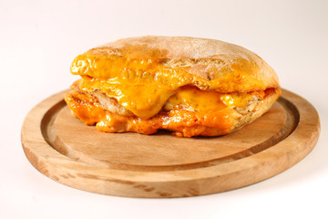 Tasty chicken steak sandwich in a ciabatta with cheddar cheese and thick romanian garlic sauce