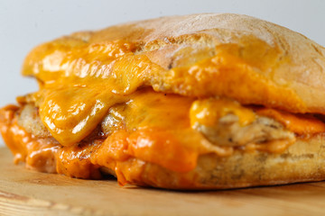 Tasty chicken steak sandwich in a ciabatta with cheddar cheese and thick romanian garlic sauce