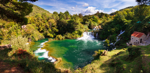 Naklejka na ściany i meble Beautiful long exposure panorama over some waterfalls of the Krka river in Krka national park in Croatia