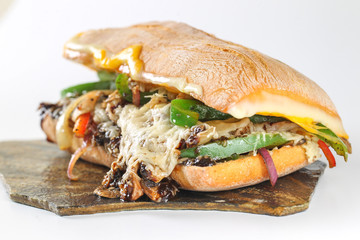 Tasty vegetarian sandwich in a ciabatta on a wodden plate