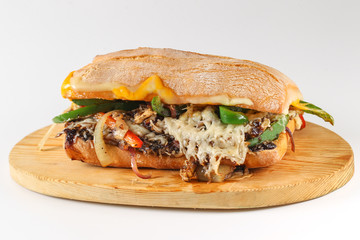 Tasty vegetarian sandwich in a ciabatta on a wodden plate