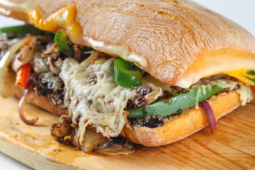 Tasty vegetarian sandwich in a ciabatta on a wodden plate