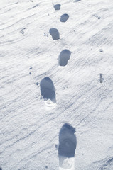 Deep steps on snow bright surface