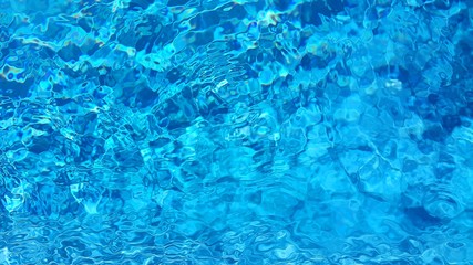 Blue pool water with sun reflection