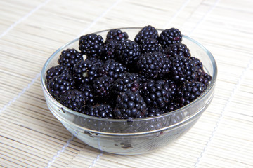 Glass bowl with ripe blackberries