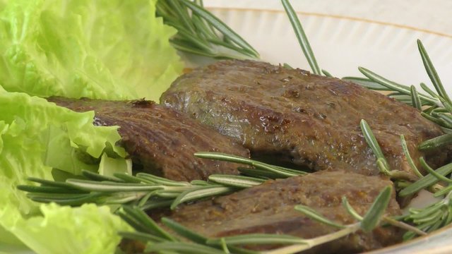 Fry meat beef with fresh herbs