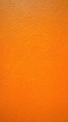 Close up of bright orange wall texture background