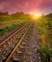railway tracks in sun raise moment with flair of sun