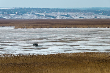 The car traveling on the ice of the river. Russia, Mius Estuary