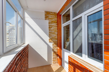 Sunny balcony with plastic windows and door - obrazy, fototapety, plakaty