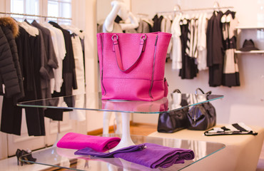 Pink women handbag in a clothing fashion store.