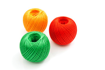 three colored tangles of thread