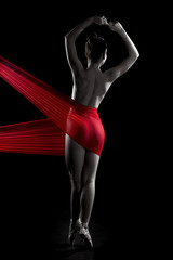 Fototapeta premium nude sexy girl on pointe with a red translucent fabric on the thighs