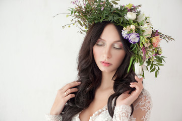 Obraz na płótnie Canvas Beautiful Woman with Curly Hair, Makeup and Flowers Wreath