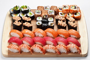 Sushi set with rolls and  nigiri   served on a wooden board 